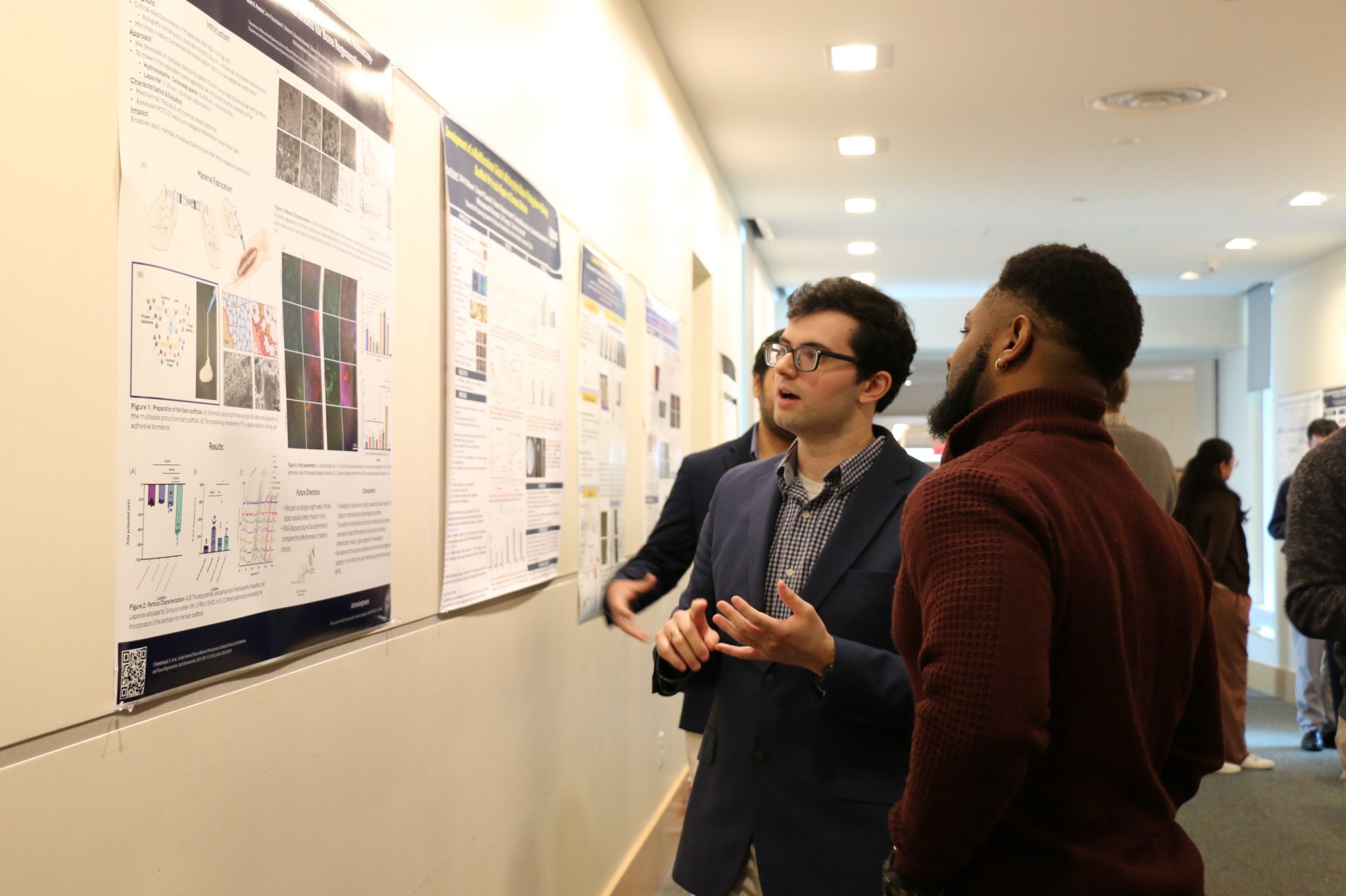 researchers infront of poster